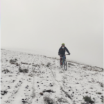 Mountain Biker riding on the snow of Cotopaxi volcano.
